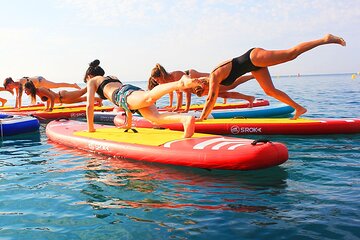 Yoga Session on Paddle Surf Board in Fenals Beach